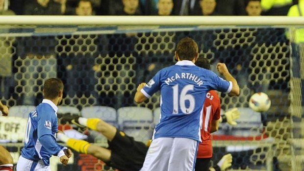 Shaun Maloney (L) scores the winner for Wigan against Manchester United.