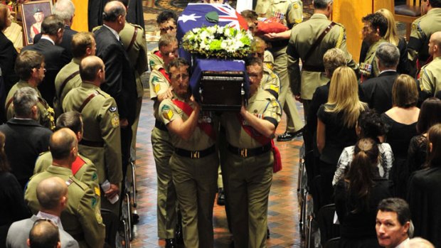 Heavy hearts: Sergeant Wood's coffin is carried from St Andrew's Cathedral in Sydney.