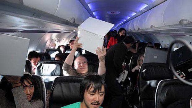 The US tech press, including Gizmodo editor Brian Lam (front row), try the onboard wi-fi service last month.