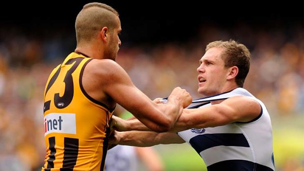 Lance Franklin and Joel Selwood have a slight disagreement.