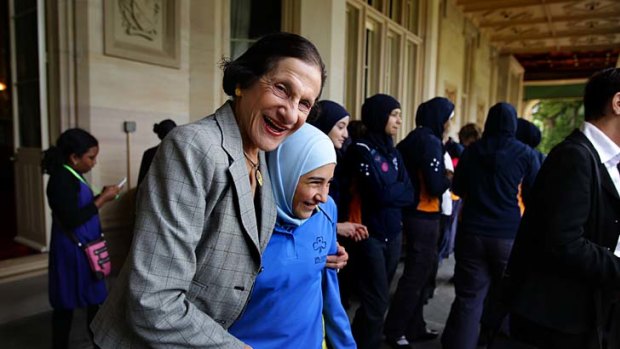 NSW Governor Marie Bashir (left) with a nerw recruit to the Girl Guides movement yesterday at Government House.