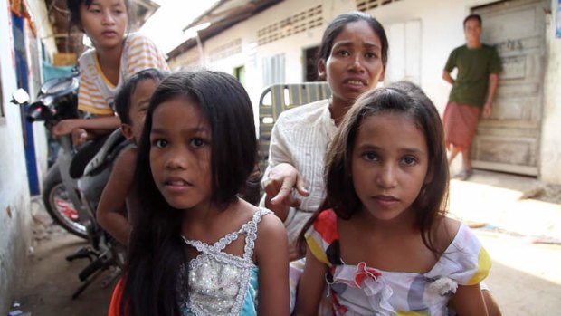 Seeking a long-term reunion: Yem Chanthy points to her daughters Chita (left) and Rosa during a visit that is supervised by the Australian-run Citipointe Church's She Rescue Home in Phnom Penh.