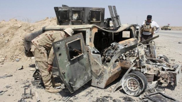 The wreckage of a Humvee belonging to Islamic State militants lies along a road after it was targeted by pro-Iraqi forces in the town of Sulaiman Pek in Salahuddin province.
