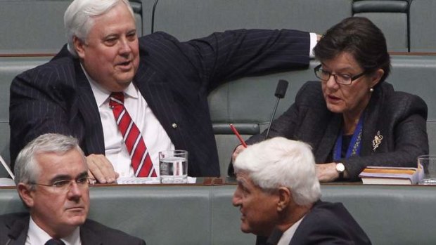 Palmer United Party MP Clive Palmer takes his seat in Parliament next to Indi indpendent Cathy McGowan with Andrew Wilkie (Tasmania) and Bob Katter (Queensland).