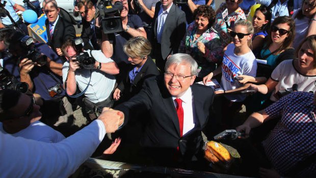 Kevin Rudd shakes hand with residents after voting in the seat of Griffith.