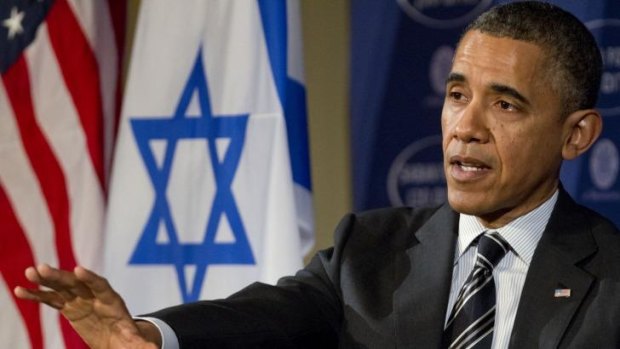 President Barack Obama gestures while speaking at the Saban Forum in Washington.