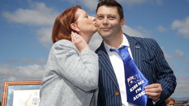 Prime Minister Julia Gillard gives new Australian citizen Ian Mears (previously from London) a kiss, at a citizenship ceremony in Canberra.