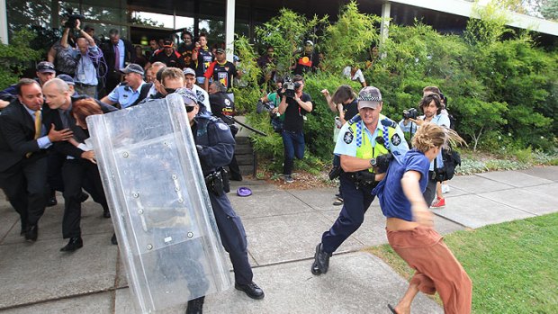 Riot police push their way through the protesters at the Lobby restaurant.