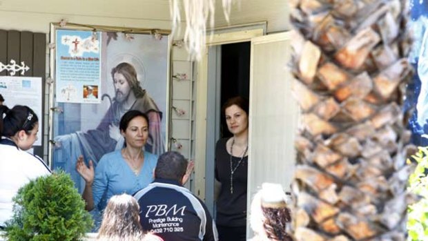 Lady of the house ... Lina Tannous, in black, welcomed visitors to her house in Guildford yesterday after police arrested her husband, George, over allegations relating to credit card fraud.