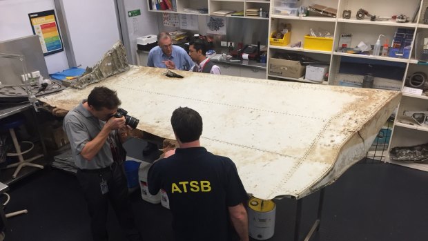 Malaysian and Australian investigators examine the piece of aircraft debris found on Pemba Island off the coast of Tanzania