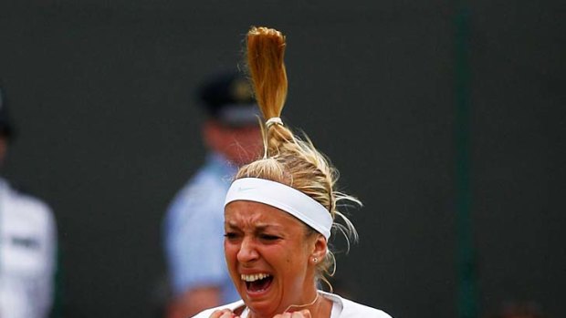 Germany's Sabine Lisicki sinks to her knees in ecstasy after her victory.