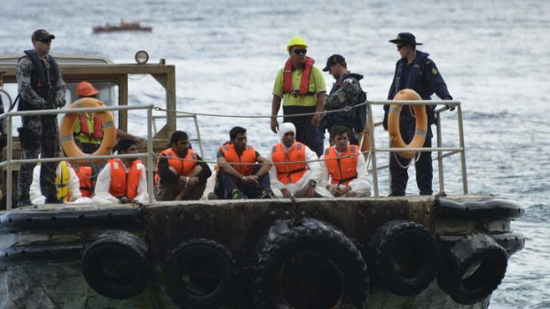 The HMAS Parramatta offloads on Christmas Island asylum seekers from Iraq, Iran and Pakistan after their boat capsized on Tuesday.