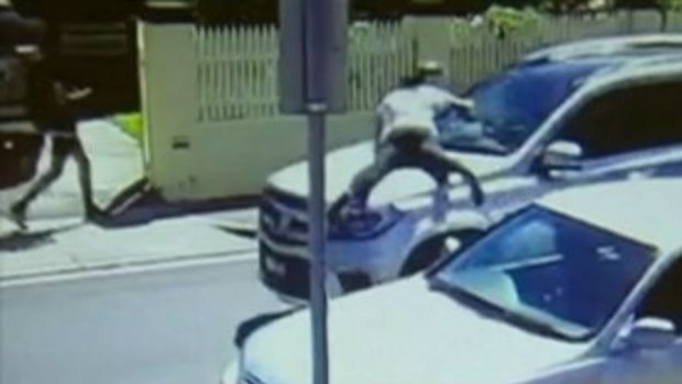 A woman leapt onto the bonnet of the car as the thief sped off.