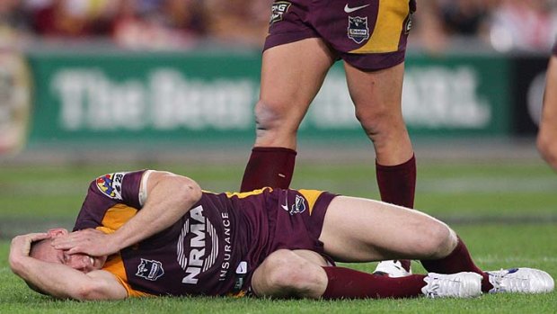 Darren Lockyer goes down with a facial injury after a collision with Broncos teammate Gerard Beale.