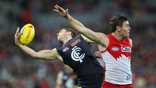 Which way?: Carlton's Marc Murphy takes a one-hand mark over Swan Craig Bird.