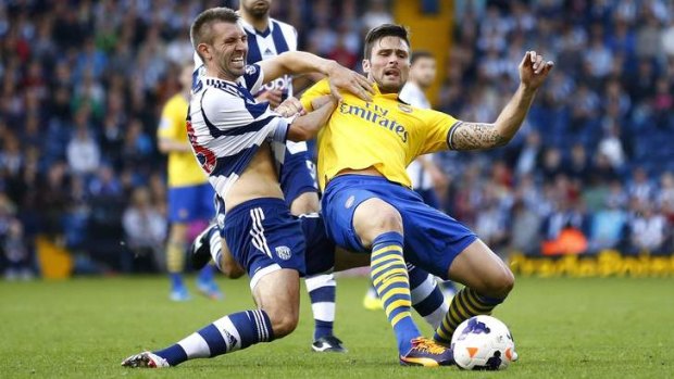 Arsenal's Olivier Giroud, right, wrestles for the ball with West Bromwich Albion's Gareth McAuley.