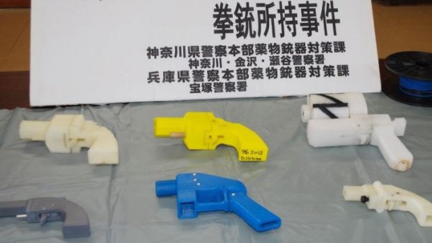 Seized plastic guns produced by a 3D printer are displayed at a police station in Yokohama, Japan.