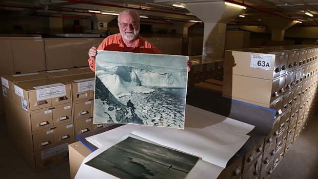 Visual DNA: Alan Davies at the State Library with a Frank Hurley photograph of Antarctica.