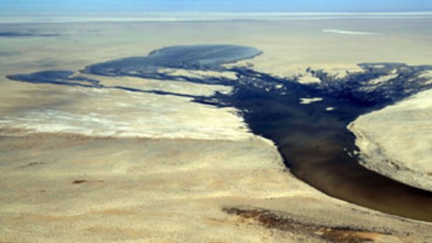 Water flows into Lake Eyre in 2007 but the outback lake has only filled three times in 160 years.
