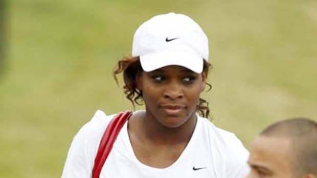 Serena Williams walks to a practice court.