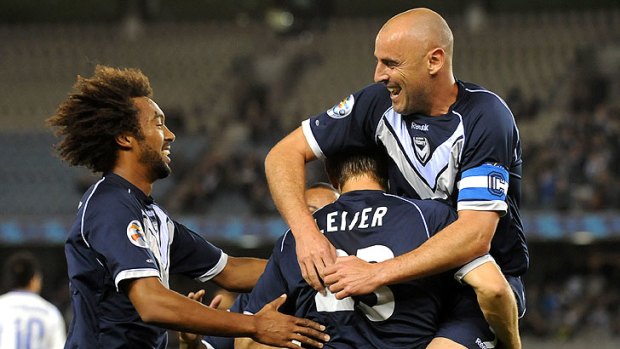 Relief: Kevin Muscat congratulates Adrian Leijer on his goal.