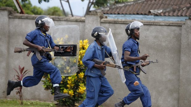 Policemen clash with protesters near a parliament building during a protest against President Pierre Nkurunziza.