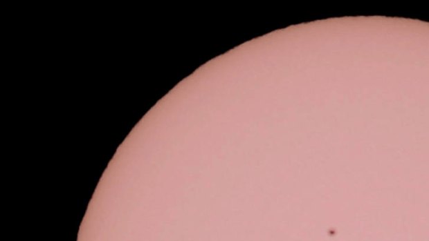 Venus is silhouetted as it passes in front of the Sun, observed from Gifu, central Japan.
