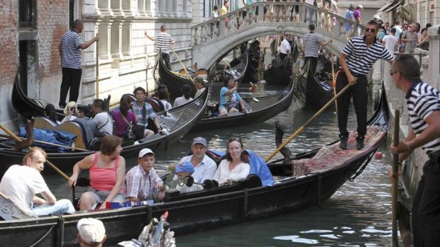 The flat-bottomed gondolas are a Venetian fixture, but they are vulnerable to the sudden wash from passing motorboats.
