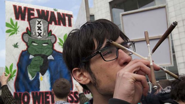 A man smokes five marijuana joints in Amsterdam during a protest against a government plan to stop foreigners from buying marijuana in the Netherlands.