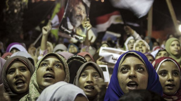 Under threat: Supporters of Mohamed Mursi hold a sit-in at Cairo University in Giza.