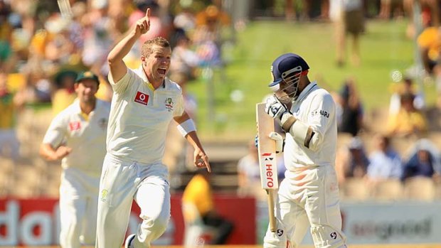 Peter Siddle leaps in the air after taking a return catch to dismiss Virender Sehwag.