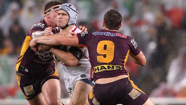 Nathan Friend tries to bust therough the Broncos' defenders.