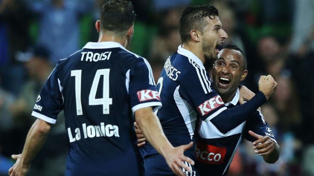 Melbourne Victory's Kostas Barbarouses (centre) celebrates his goal with James Troisi and Archie Thompson (right).