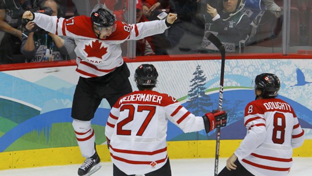Canada's Sidney Crosby celebrates after scoring the game winning goal against the U.S.