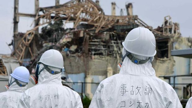 Disaster ... members of a Japanese government panel inspect the damaged building which housed reactor number three at Fukushima in June, 2011.