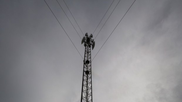 Internet company owner Jeremy Rich stands next to one of his internet towers in Melbourne.