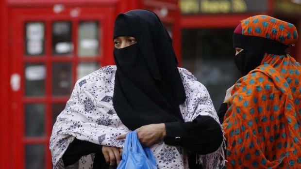 Women wear full-face veils as they shop in London. The British government is struggling with how to better integrate Britain's Muslim community without impinging on their civil liberties.