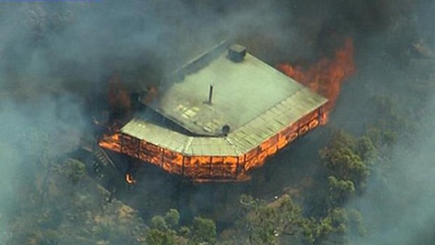 A Roleystone home is engulfed by a bushfire.