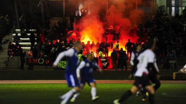 Wanderers supporters light flares into the crowd during a match against Canberra Olympic at the AIS last year..