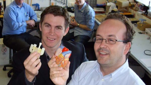 Dr John Fraser and Dr Daniel Timms, lead biomedical engineer for BiVacor, holding a model of the pump device and a model of the human heart for comparison.