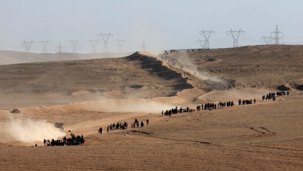 Displaced Iraqis flee their homes on the western side of Mosul, Iraq.