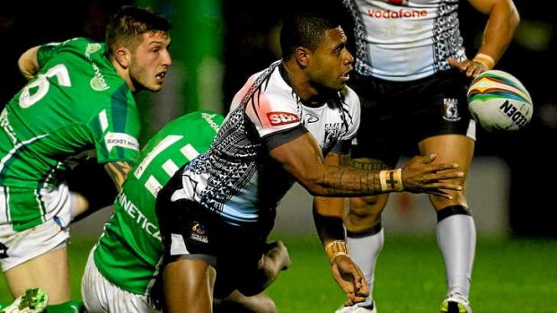 Kevin Naiqama of Fiji offloads after a busting the Irish defence.