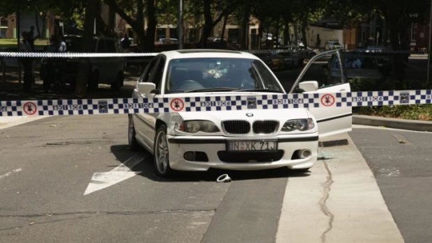 The BMW at the centre of a Sydney-wide police pursuit sits outside Surry Hills Police Station, its windscreen riddled with bullet holes.