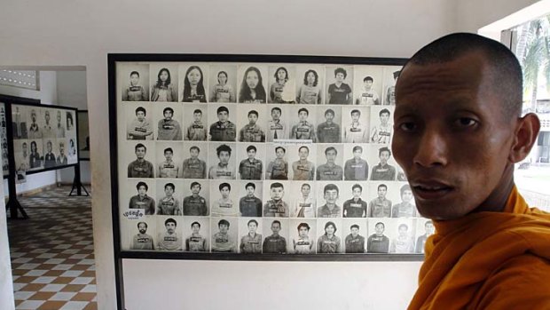 Faces of genocide: A Buddhist monk in the museum at the former Tuol Sleng prison where the Khmer Rouge held thousands of prisoners before sending them to their deaths.