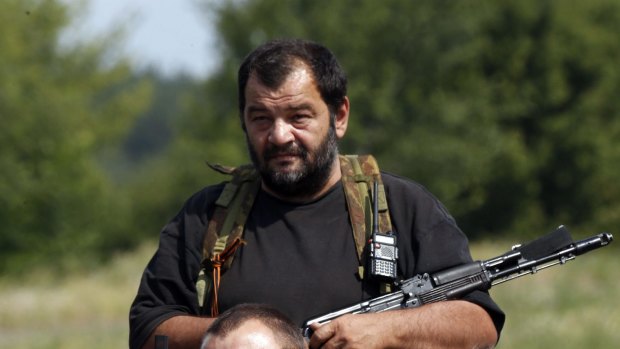A pro-Russian separatist guards a checkpoint in the settlement of Yasynuvata outside Donetsk.