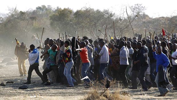 Intimidating ... protesters in South Africa march forward together, clutching spears.