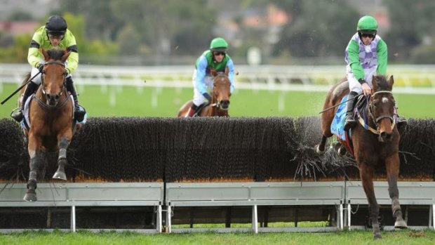 John Allen riding Wells (right) in the Grand National Steeplechase.