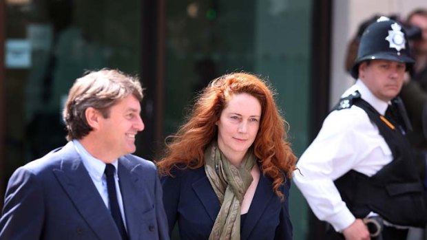 Former News International chief executive Rebekah Brooks and her husband Charlie Brooks leave Westminster Magistrates' Court in London.