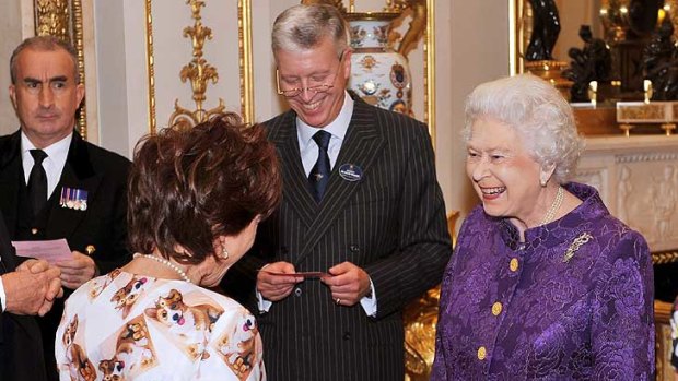 We are very amused ... the Queen reacts to Kathy Lette's corgi chic.
