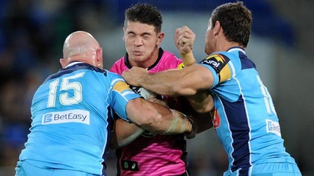 Panthers forward Adam Docker is crunched by the Titans defence during the win over the Gold Coast last Saturday night.